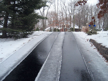 Asphalt driveway with heated tire tracks