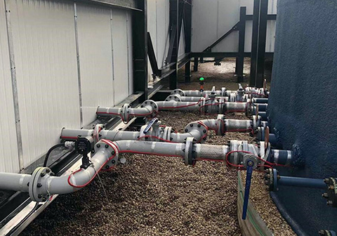 Heat trace cable installed on pipes at industrial facility.