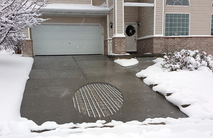Concrete heated driveway with cutout showing heating cables.