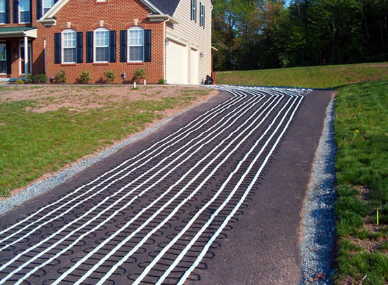 Asphalt driveway being retrofitted with radiant heat.