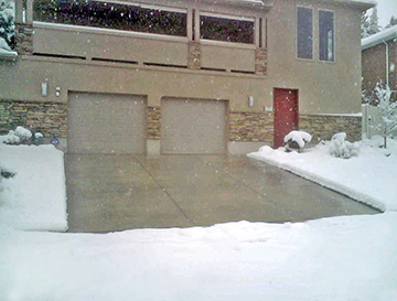 A concrete heated driveway in operation during a snowstorm.