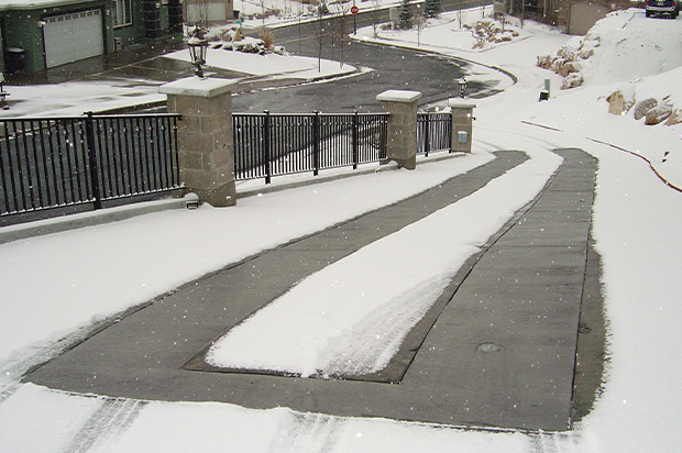 A driveway with two 24-inch wide heated tire tracks