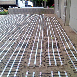 Snow melting mats being installed for heated driveway