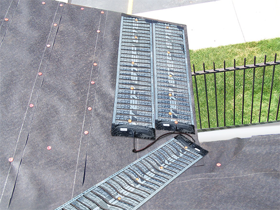 ProLine's STEP low-voltage, self-regulating roof heating panels installed in roof valley and along eaves.