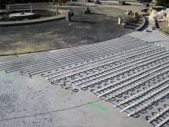 Heat cable in mats being installed for heated driveway.